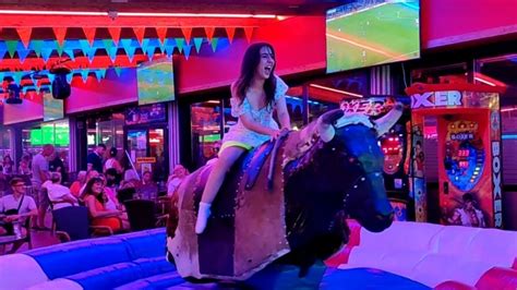 brunette riding|Brunette Girl in White Skirt Riding on a Bull in Benidorm 